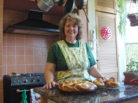 picture of author with braided bread wreath and baskets of 'Easter bread'